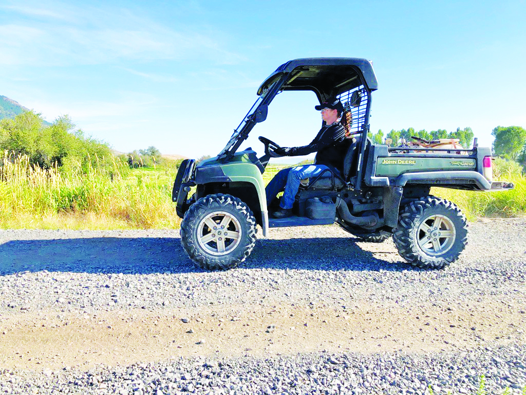 Woman driving a UTV on the farm