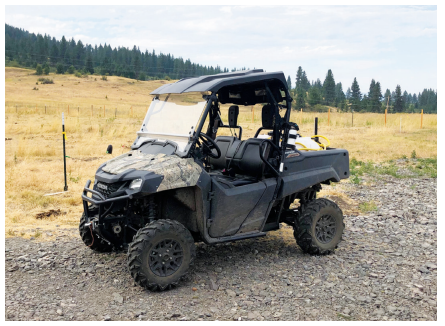 Man driving a UTV on a farm
