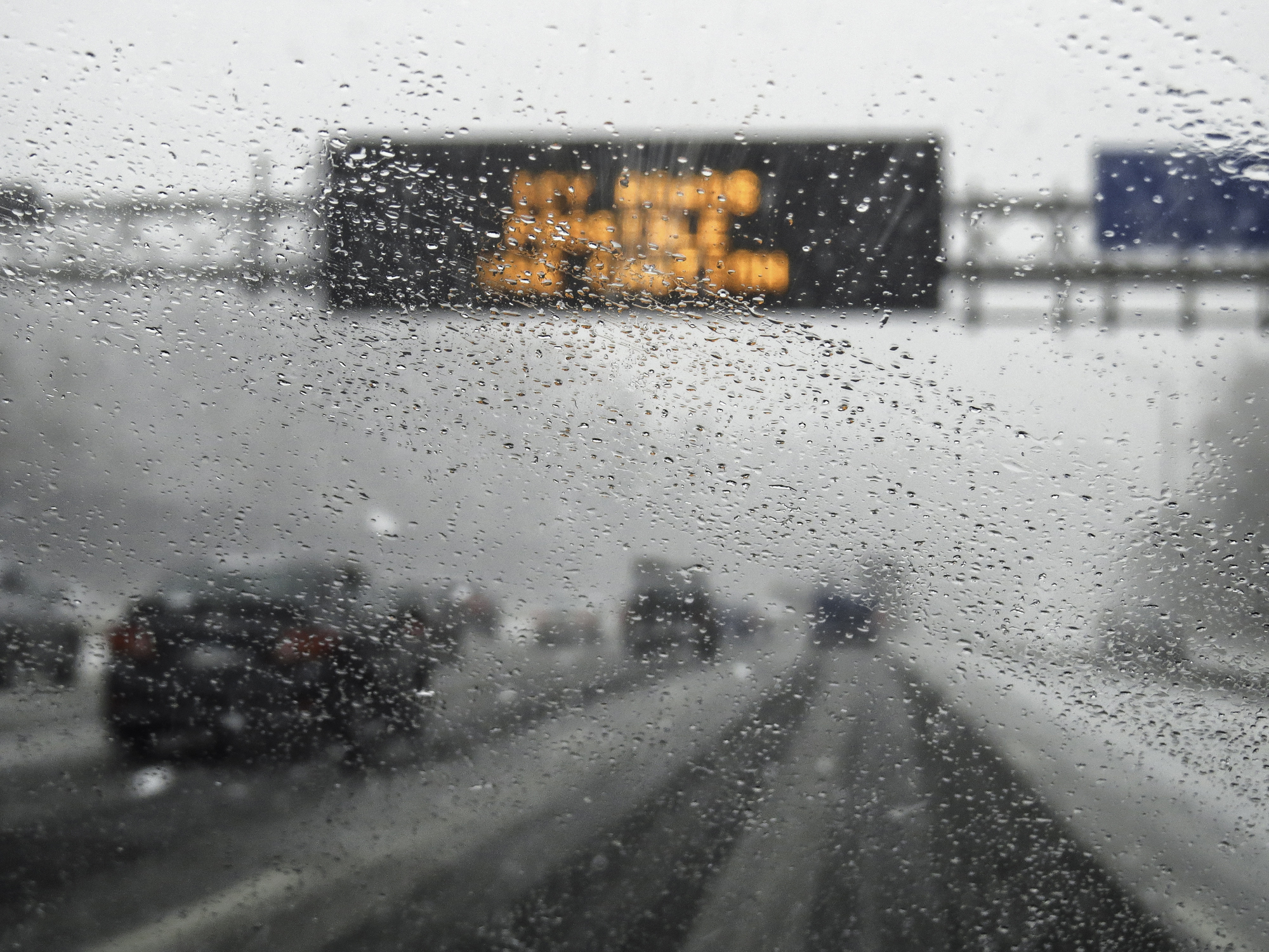 Traffic on icy freeway with sign